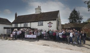 Residents of Roxwell celebrate purchasing the pub on 13th April 2024 with a banner that reads "Thank you for your support"
